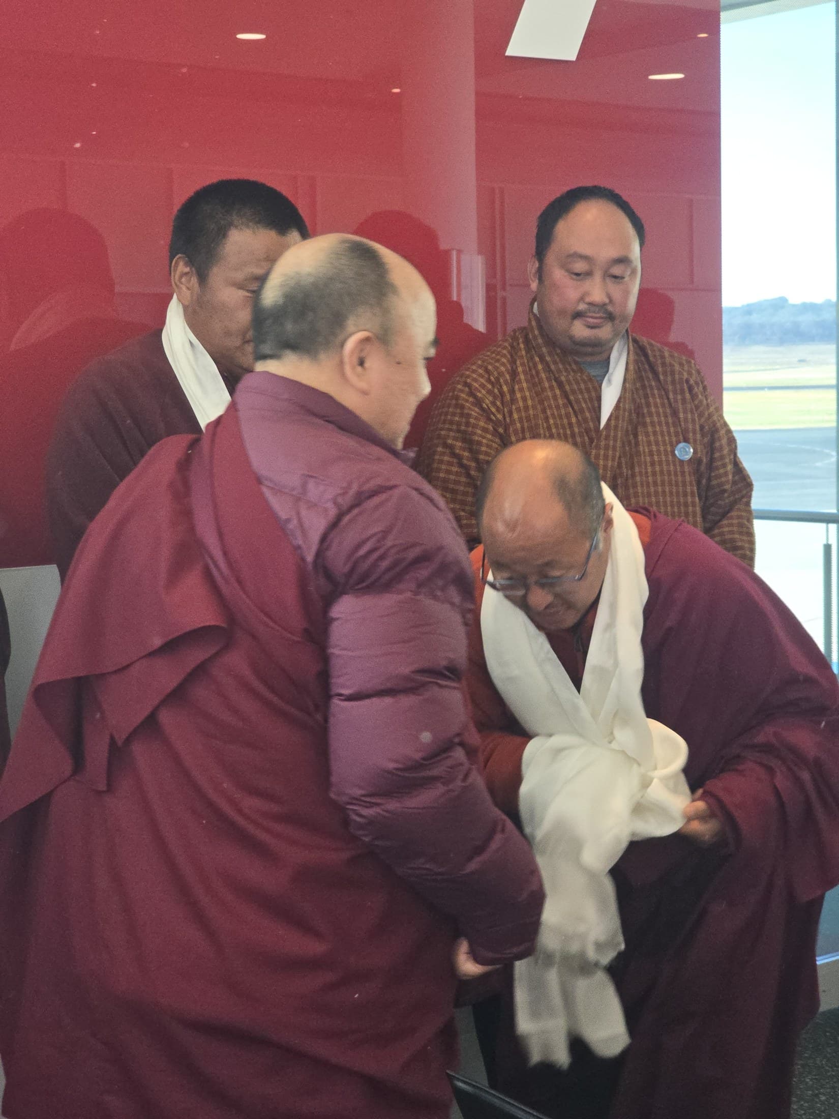 Devotees offering khadar and final respects to Kyabje Namkhai Nyingpo Rinpoche at Canberra Airport