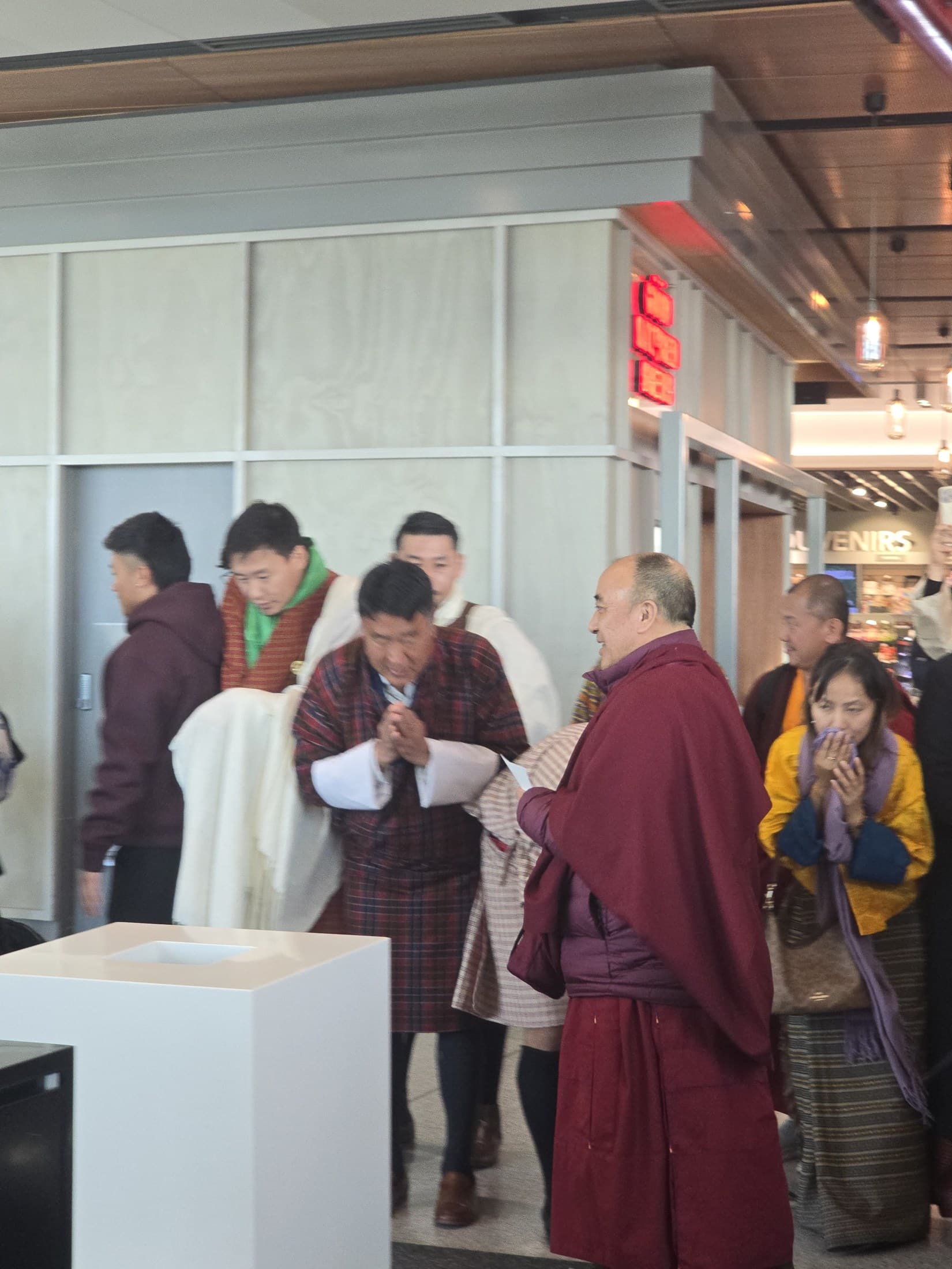 Kyabje Namkhai Nyingpo Rinpoche pausing for a final moment with devotees at Canberra Airport